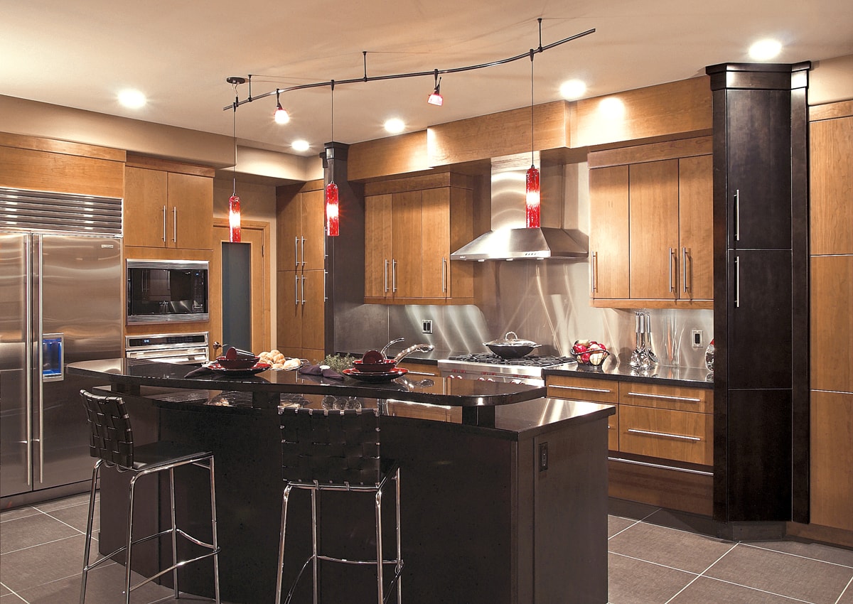 Light and dark warm wood cabinetry with slab style doors.